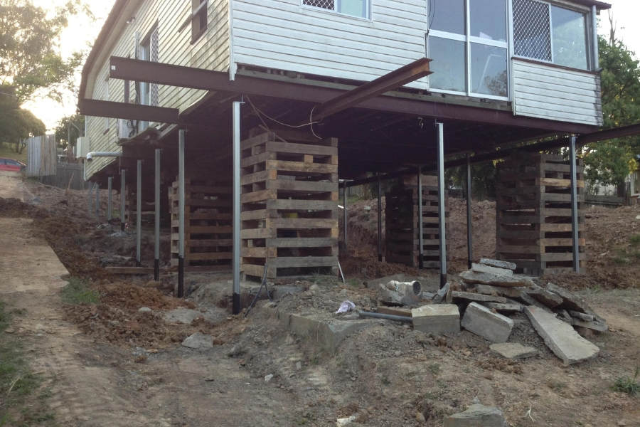 Raised pier and beam house supported during repair
